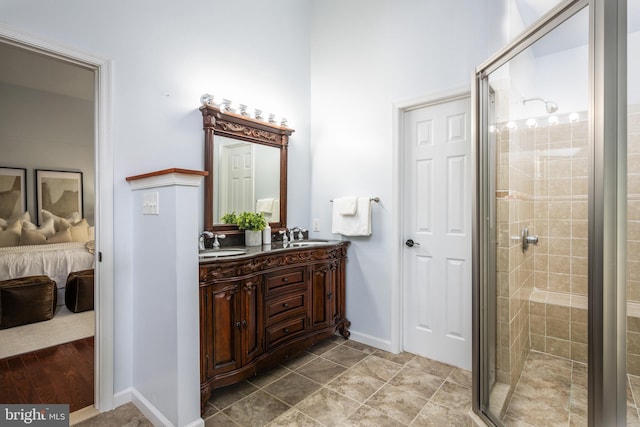 bathroom featuring a shower with door, vanity, and tile patterned flooring