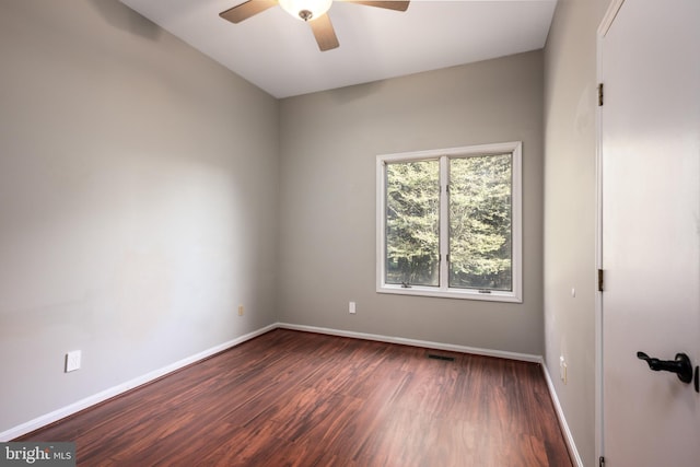 empty room with dark wood-type flooring and ceiling fan