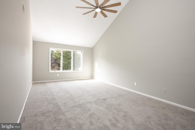 unfurnished room featuring light carpet, ceiling fan, and vaulted ceiling