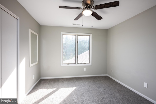 spare room with carpet floors and ceiling fan