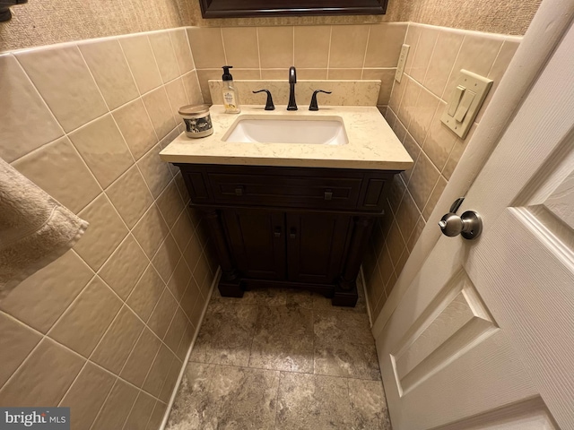 bathroom with tile walls and vanity