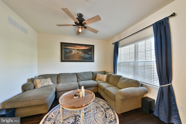 living room with ceiling fan and dark hardwood / wood-style flooring