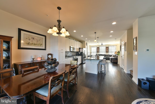 dining room featuring an inviting chandelier and dark hardwood / wood-style floors