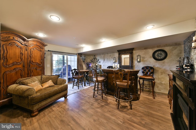 interior space with bar and hardwood / wood-style flooring