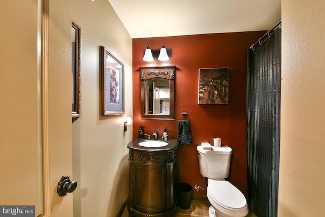 bathroom featuring vanity, toilet, and tile patterned flooring