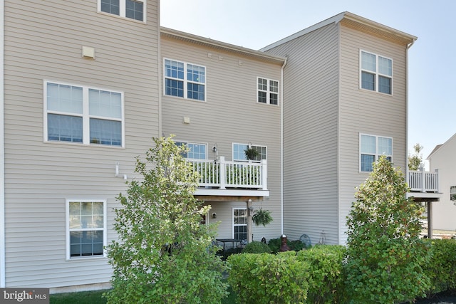 rear view of property with a balcony