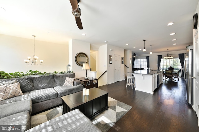 living room featuring dark wood-type flooring and an inviting chandelier