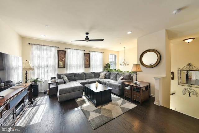 living room featuring dark hardwood / wood-style floors and ceiling fan with notable chandelier