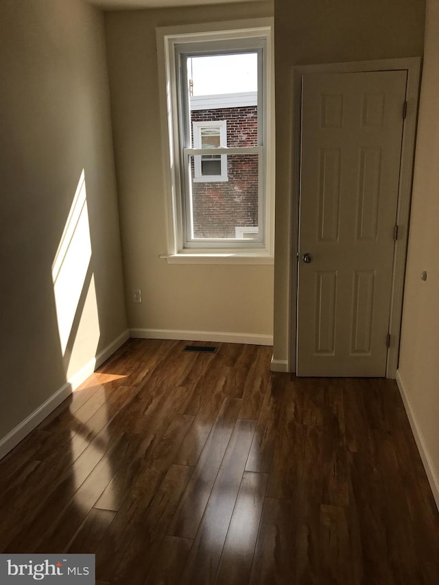 empty room featuring dark hardwood / wood-style flooring