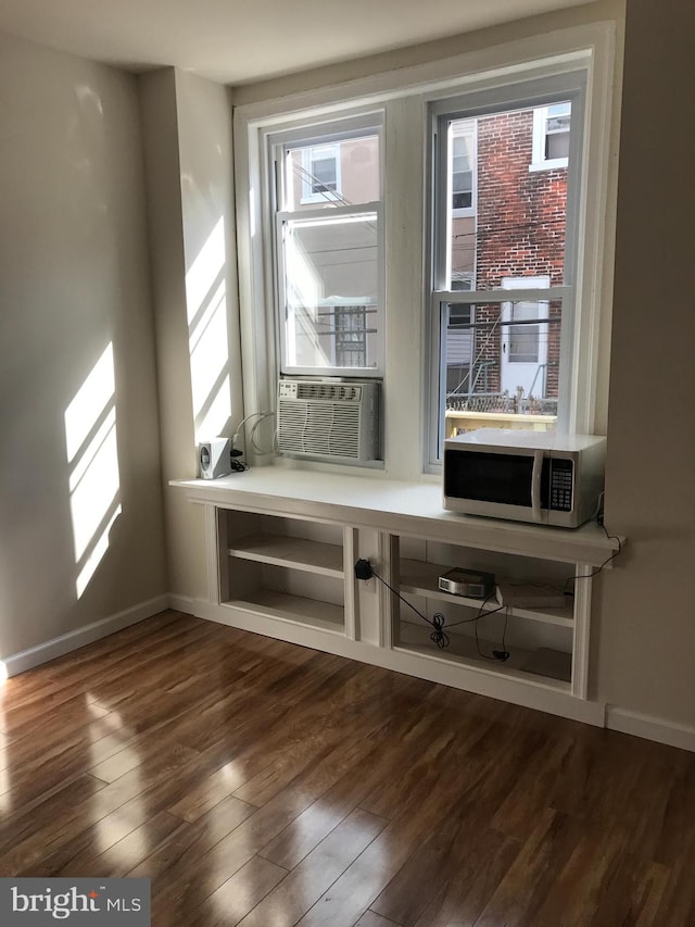 interior space featuring hardwood / wood-style flooring and cooling unit