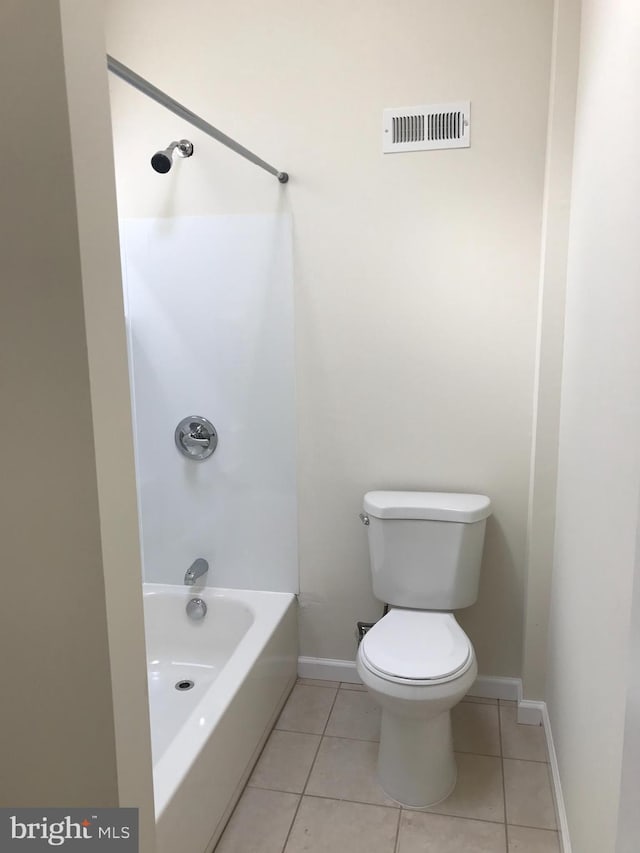 bathroom with toilet, bathing tub / shower combination, and tile patterned floors