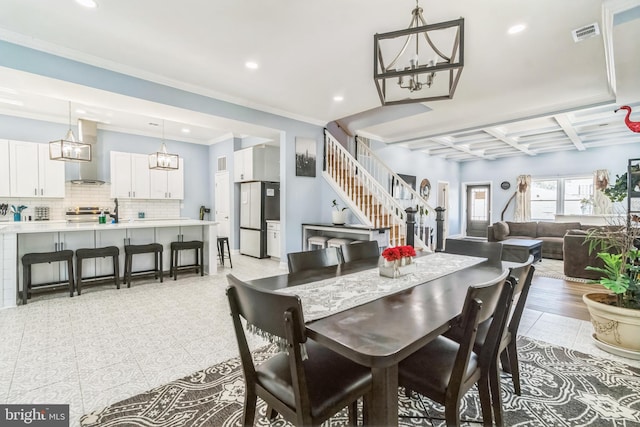 tiled dining area featuring beam ceiling, crown molding, and coffered ceiling