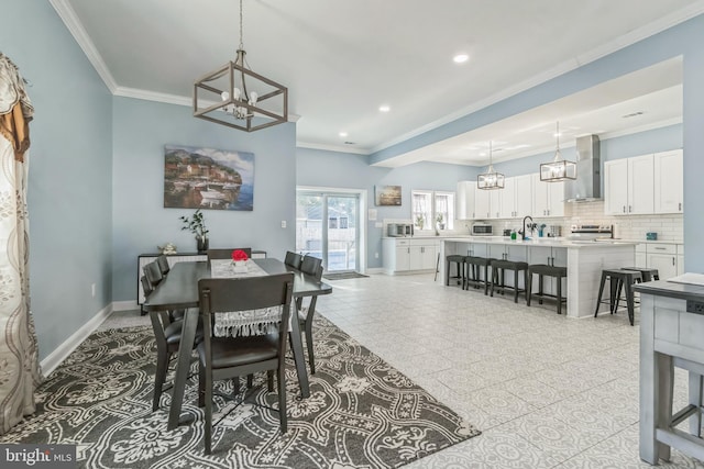 dining area with crown molding and sink