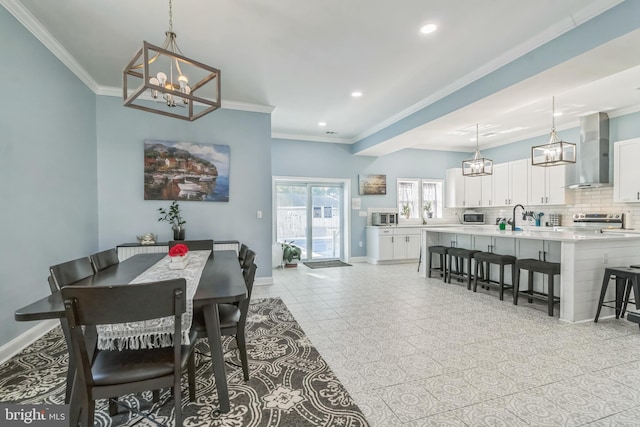 tiled dining area featuring ornamental molding and sink