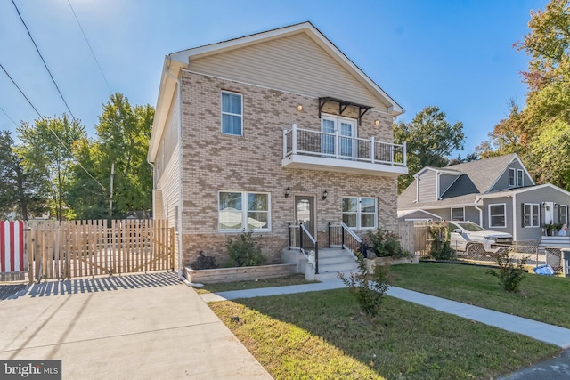 view of front of property featuring a balcony and a front lawn