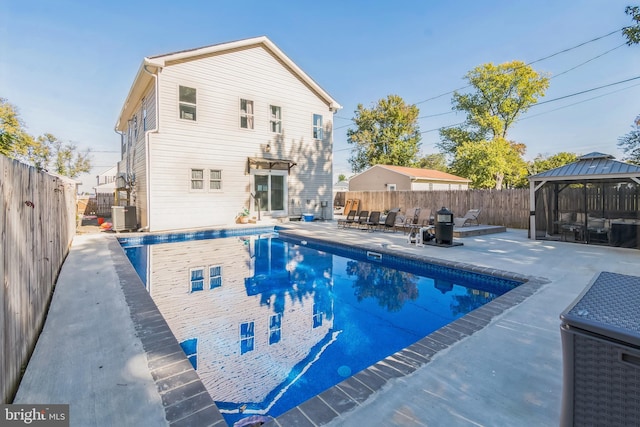 view of pool featuring a gazebo, a patio area, and central air condition unit