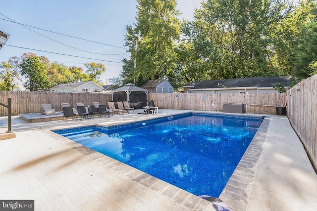 view of swimming pool featuring a gazebo and a patio