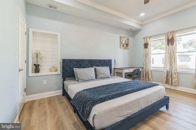 bedroom featuring ceiling fan, light hardwood / wood-style floors, and ornamental molding