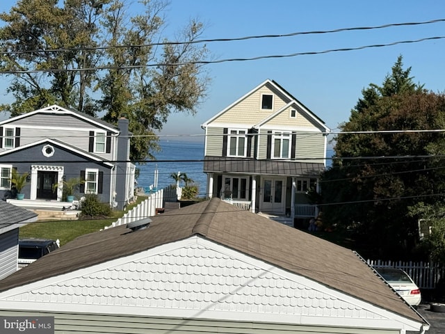 view of front property featuring french doors and a water view