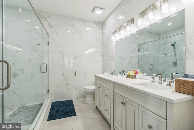 bathroom featuring vanity, a shower with shower door, tile walls, and toilet