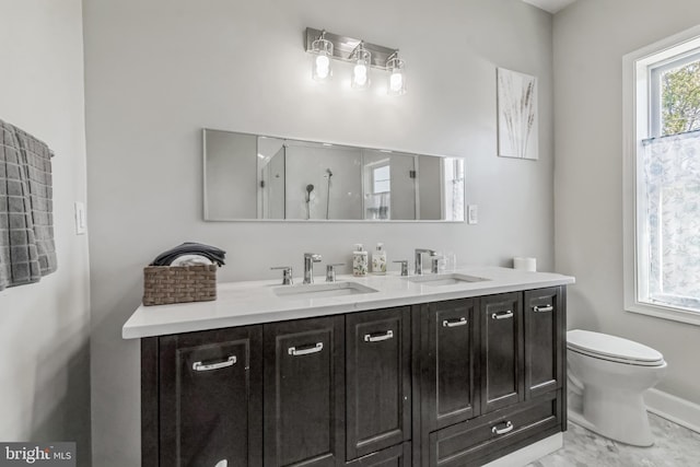 bathroom with vanity, toilet, and walk in shower