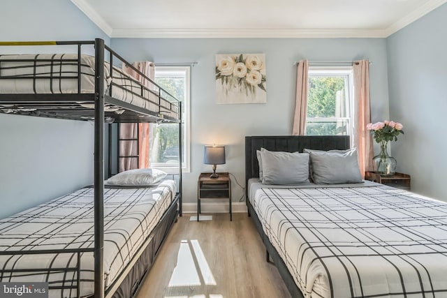 bedroom featuring hardwood / wood-style floors and ornamental molding