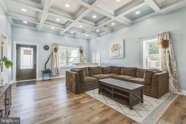 living room with beam ceiling, a wealth of natural light, light hardwood / wood-style flooring, and coffered ceiling