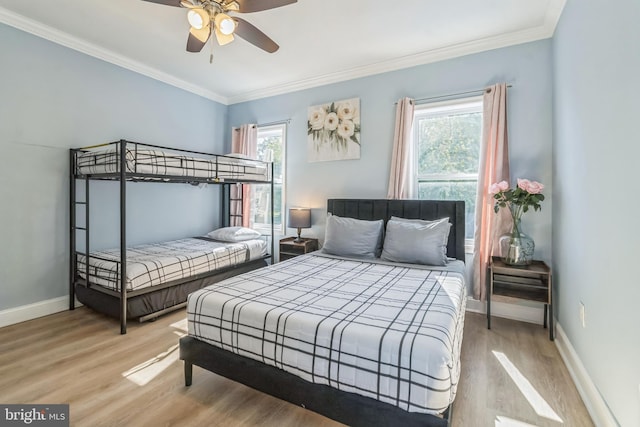 bedroom with ceiling fan, ornamental molding, and hardwood / wood-style flooring