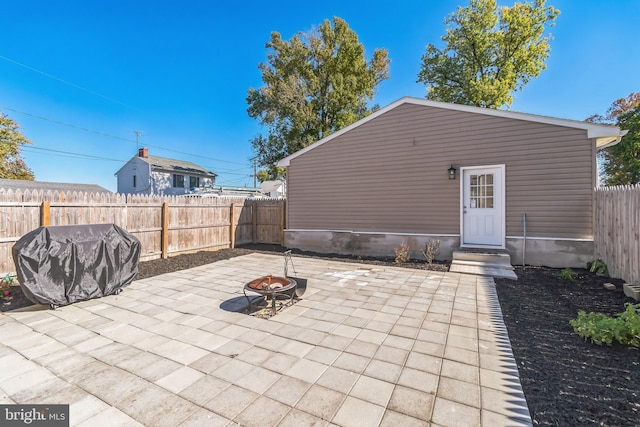 view of patio featuring a grill and an outdoor fire pit