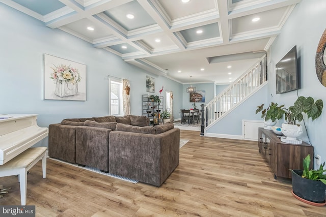 living room with coffered ceiling, beam ceiling, ornamental molding, and light hardwood / wood-style flooring