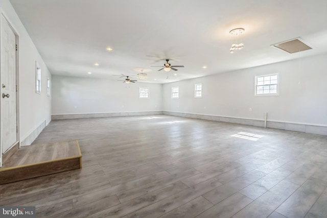 empty room with ceiling fan and light hardwood / wood-style floors