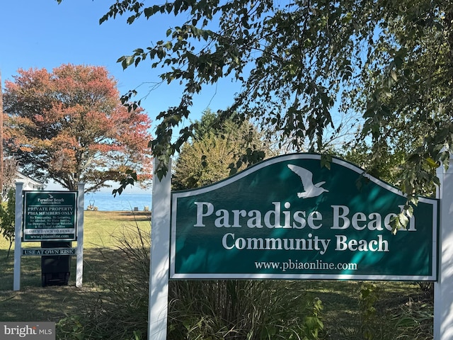 community / neighborhood sign featuring a water view