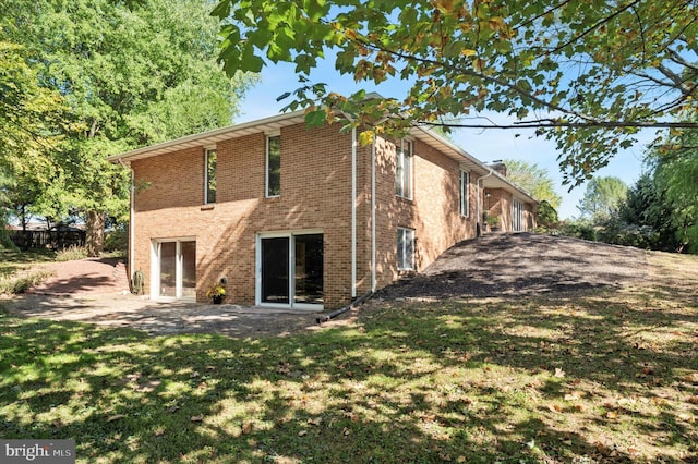 rear view of house with a lawn