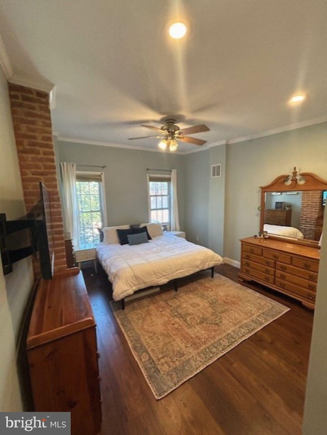 bedroom featuring crown molding, dark wood-type flooring, and ceiling fan