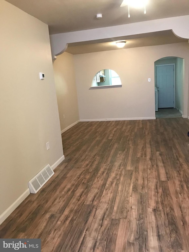 basement with dark hardwood / wood-style flooring