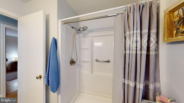 bathroom with wood-type flooring and walk in shower