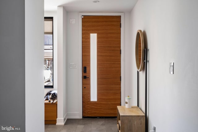 entryway with light tile patterned flooring