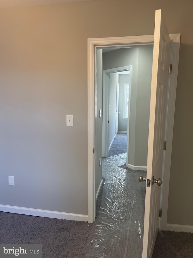 corridor with dark colored carpet