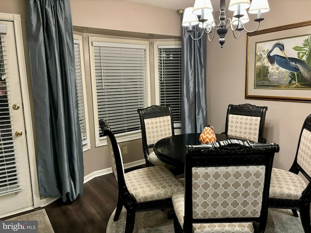 dining room featuring an inviting chandelier and hardwood / wood-style flooring