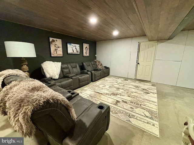 home theater room with wooden ceiling and concrete flooring