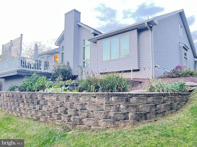 view of side of property with a deck