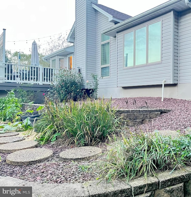 view of side of property featuring a wooden deck