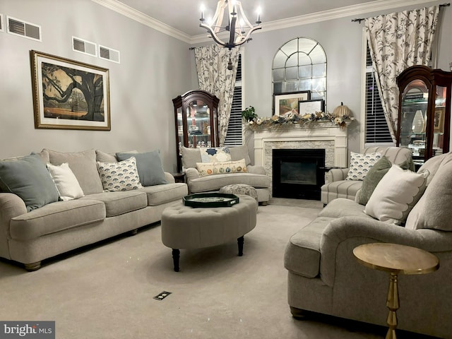 carpeted living room with a stone fireplace, a chandelier, and ornamental molding