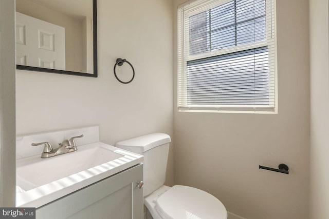 bathroom with vanity, toilet, and plenty of natural light