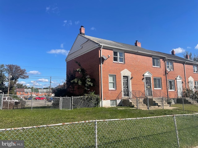 back of house with a lawn