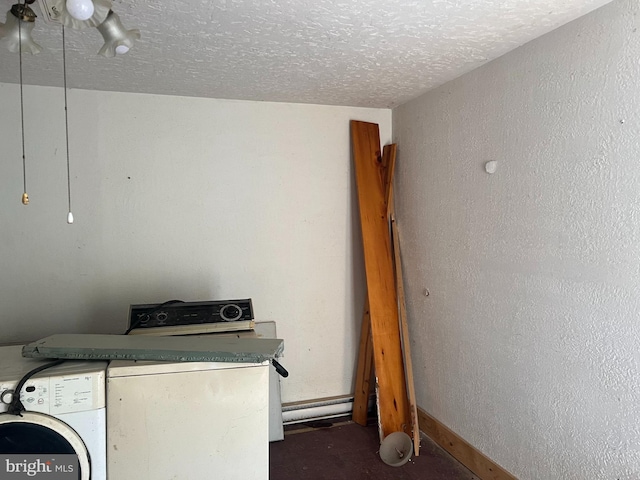 laundry room with a textured ceiling and washing machine and dryer