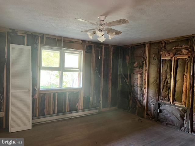 misc room featuring a baseboard heating unit, hardwood / wood-style flooring, a textured ceiling, and ceiling fan