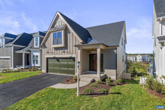 view of front of property featuring a front yard and a garage