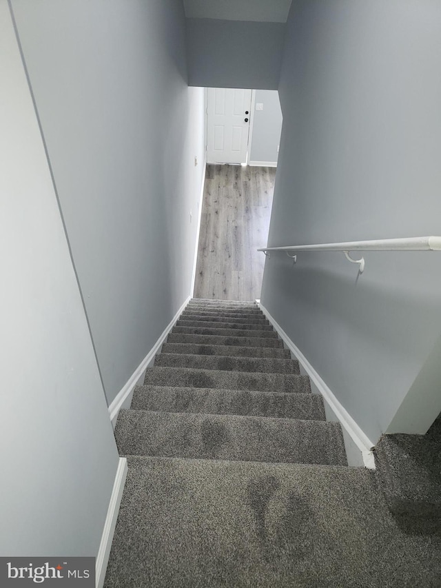 staircase with wood-type flooring