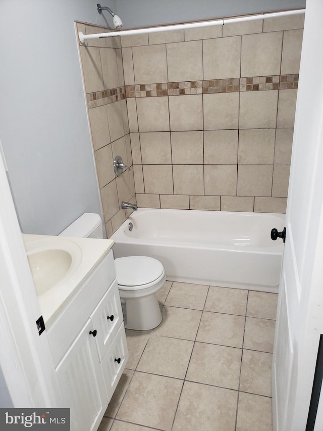 full bathroom with vanity, tile patterned flooring, toilet, and tiled shower / bath